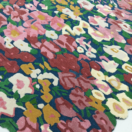 Full view of colorful floral area rug with burgundy pink green and cream flowers