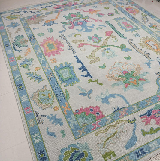 Decorative rug with colorful floral and geometric patterns on a light background