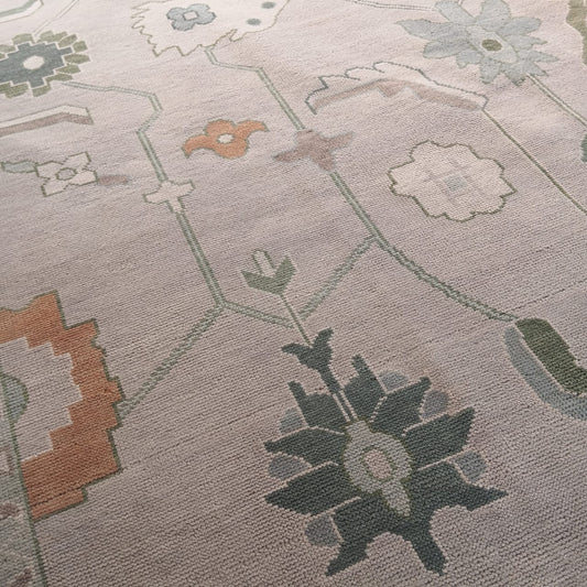 Close-up of a patterned rug with geometric shapes and floral elements.