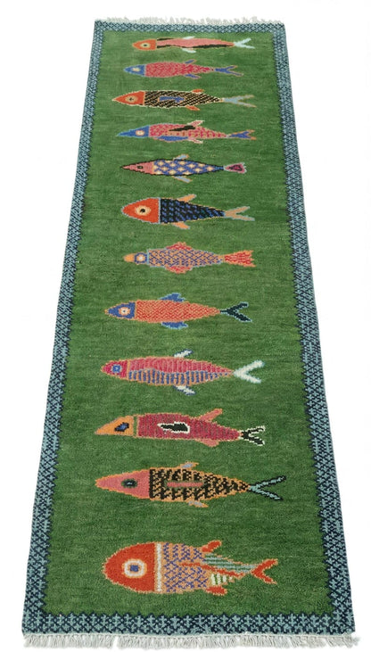 Green runner rug Oushakaura with colorful fish patterns on a white background