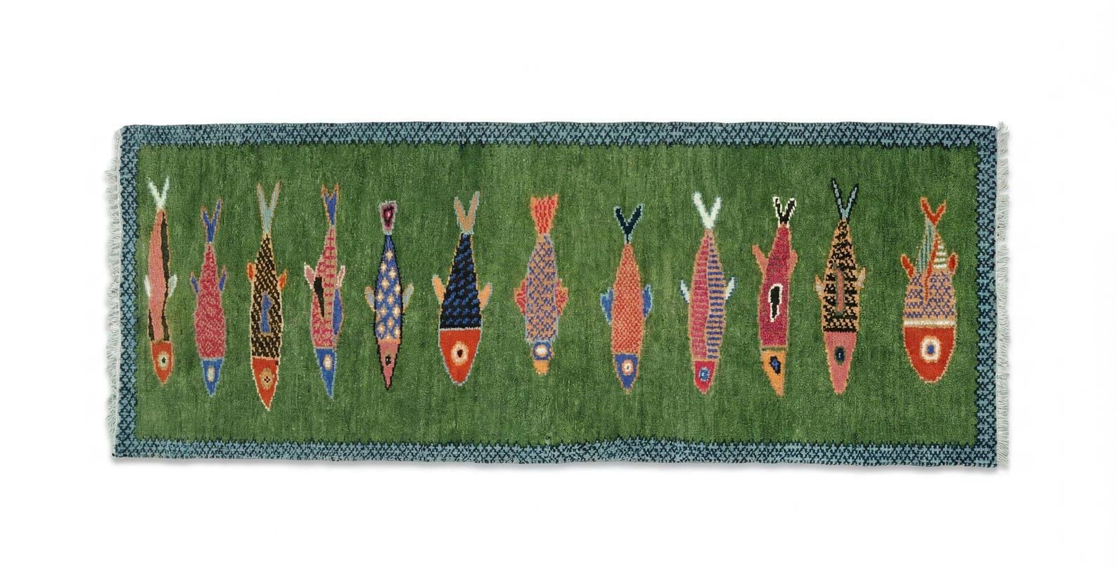 Decorative Oushakaura rug with colorful fish pattern on a green background