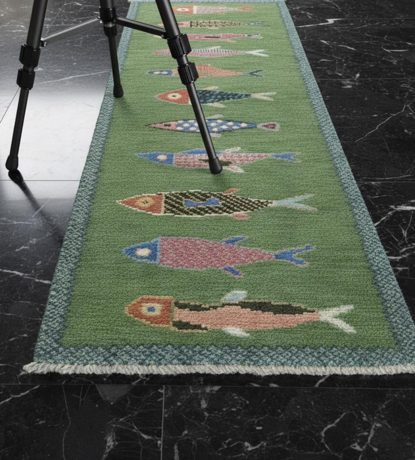 Green children's rug with fish pattern on a dark marble floor