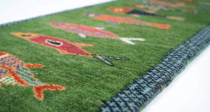 Closeup texture of handmade Oushakaura fish runner rug showing artisan wool craftsmanship