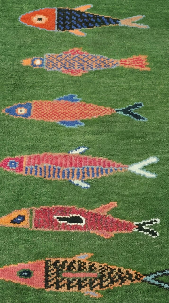Closeup texture of handmade Oushakaura fish runner rug showing artisan wool craftsmanship