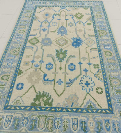 Handcrafted Oushak flatweave rug featuring blue and sage traditional motifs
