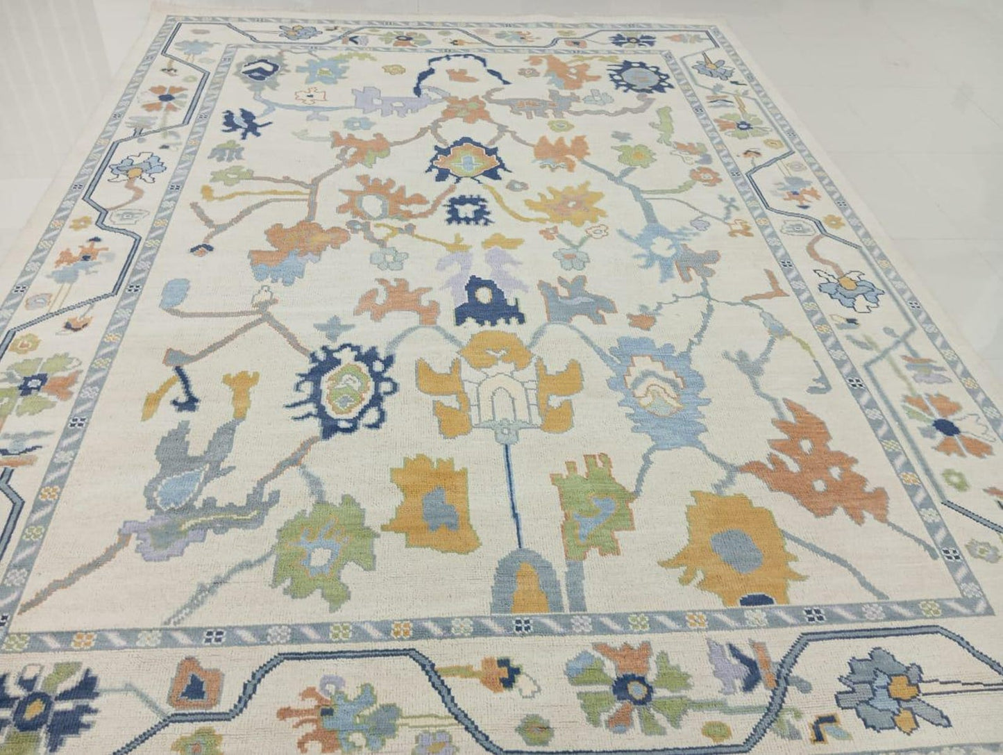 Antique style Oushak wool rug handwoven with multicolor floral motifs