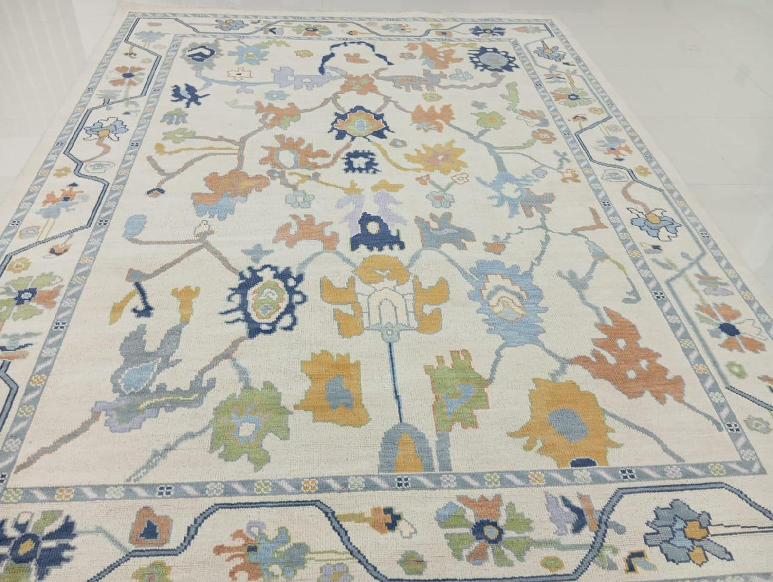 Antique style Oushak wool rug handwoven with multicolor floral motifs