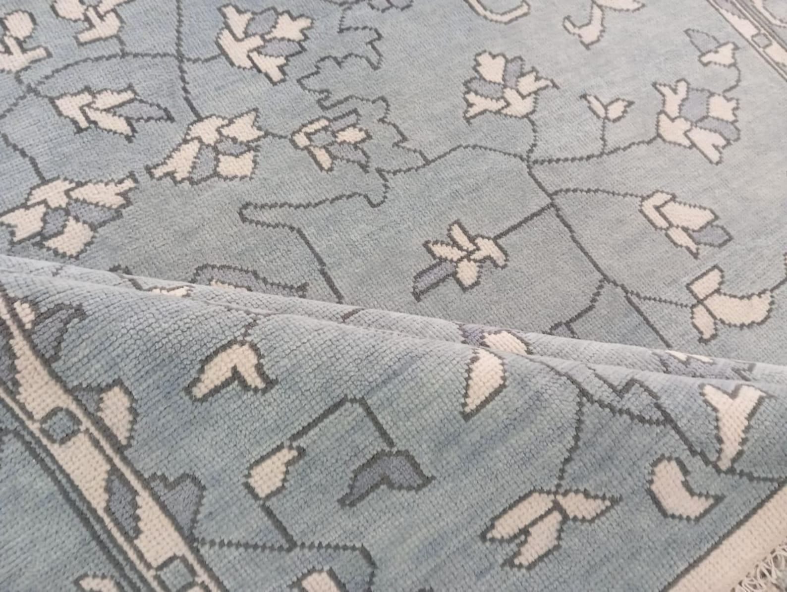 Close-up of artisan handwoven wool rug floral design