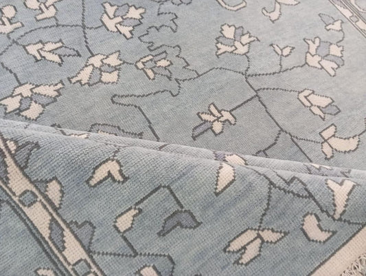 Close-up of artisan handwoven wool rug floral design