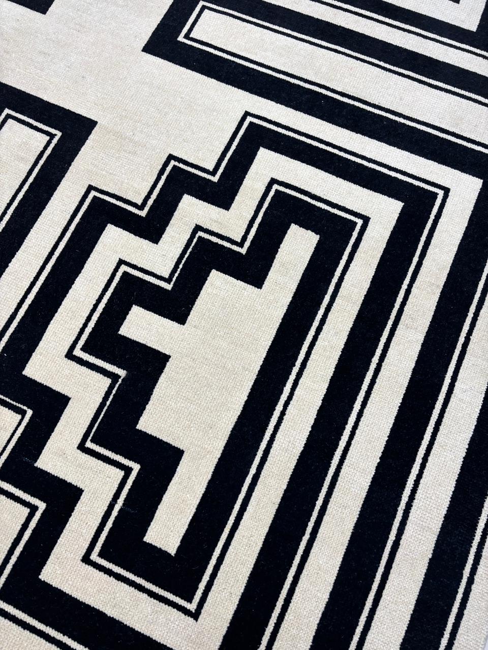Geometric pattern detail on black and ivory wool rug
