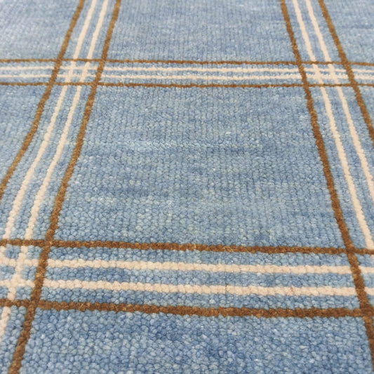 Modern blue checkered wool area rug with ivory and brown lines