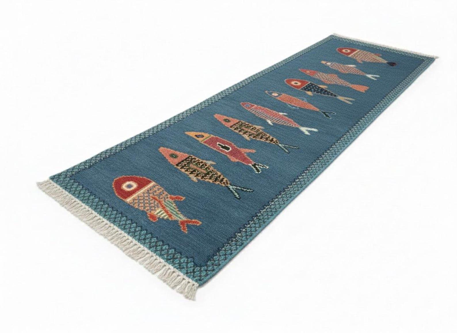 Blue handmade fish runner rug angled product view with fringe edges