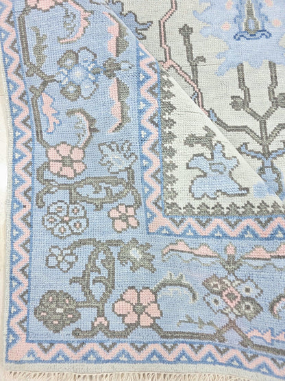 Blue floral runner with ornate pink and blue decorative border and botanical motifs