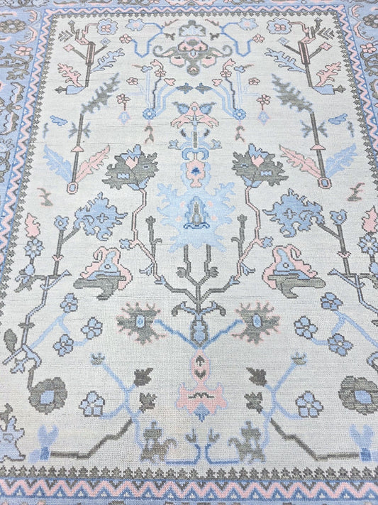Blue floral traditional runner rug with pink, sage and grey botanical motifs