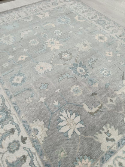 Close-up of a patterned rug with floral designs on a neutral background