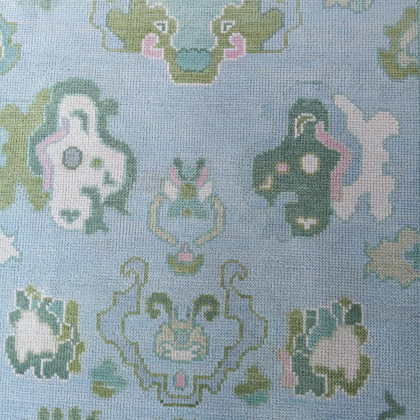 Side view showing low pile flatweave construction of blue and ivory wool rug