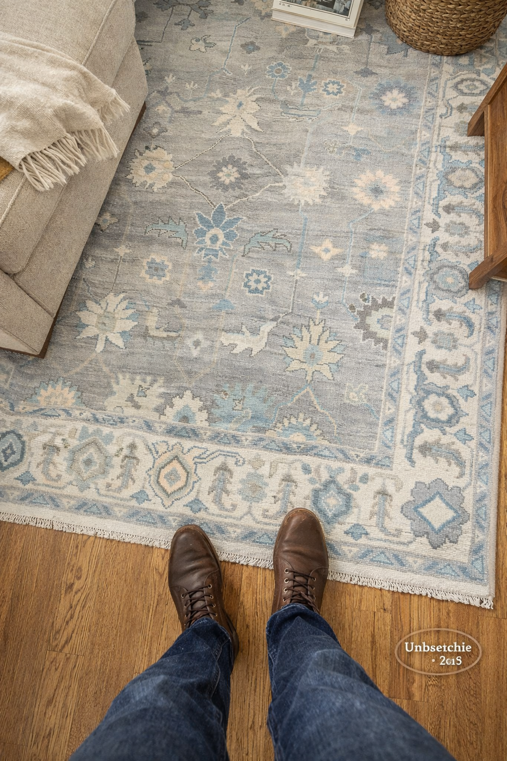 Blue and ivory Oushak area rug in real living room setting with natural light, traditional Turkish style rug on hardwood floor
