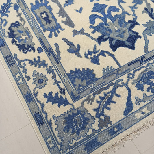 Floral pattern detail on handwoven blue Oushak rug
