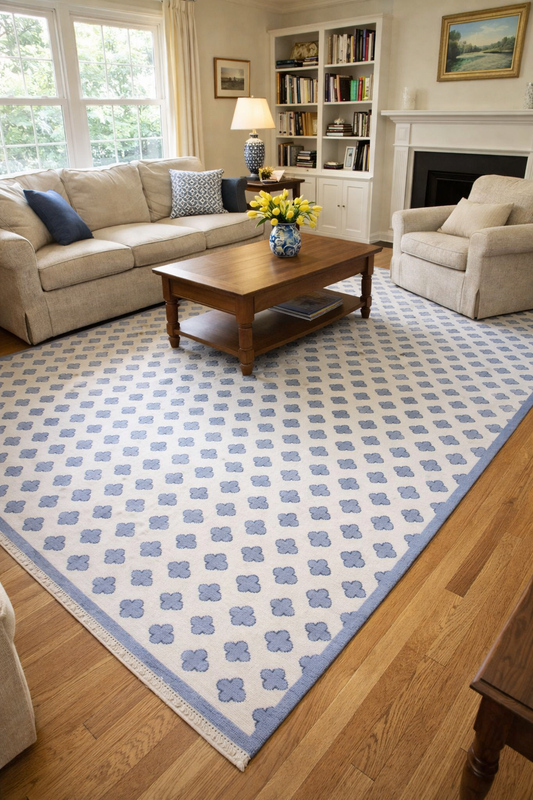 Blue and ivory geometric area rug styled in modern living room with sofa and wooden coffee table