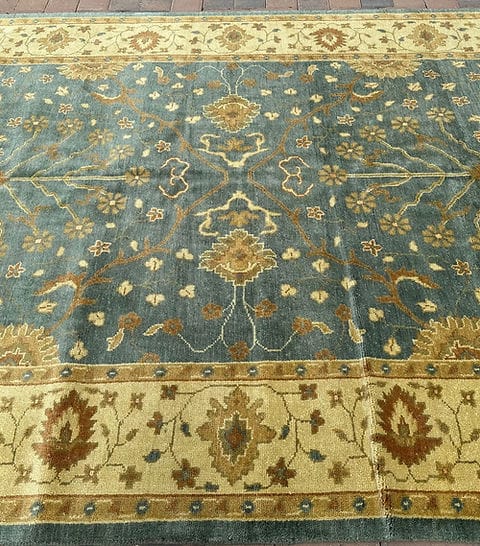Handmade Blue Oushak Rug featuring traditional floral motifs, ivory border, and premium wool craftsmanship