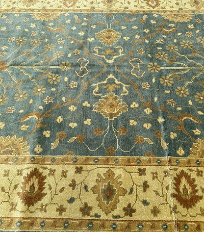 Handmade Blue Oushak Rug featuring traditional floral motifs, ivory border, and premium wool craftsmanship