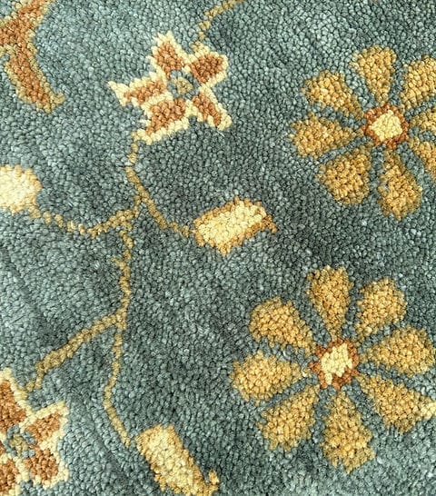 Handmade Blue Oushak Rug featuring traditional floral motifs, ivory border, and premium wool craftsmanship