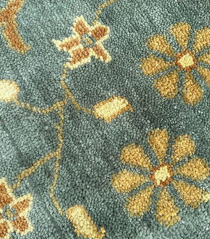 Handmade Blue Oushak Rug featuring traditional floral motifs, ivory border, and premium wool craftsmanship