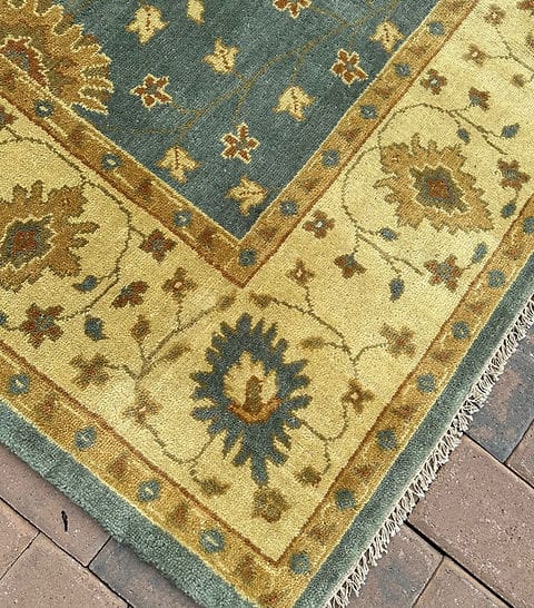 Handmade Blue Oushak Rug featuring traditional floral motifs, ivory border, and premium wool craftsmanship