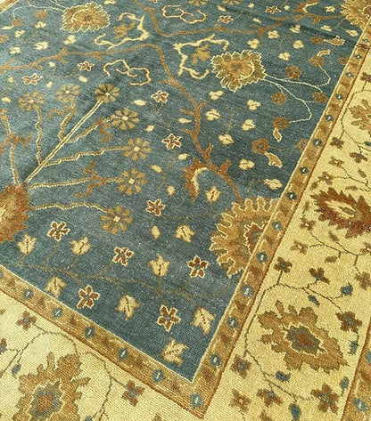 Close-up of a floral patterned rug with blue and gold colors.