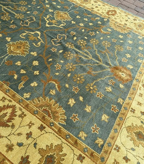 Close-up of a patterned rug with floral designs on a blue and yellow background.