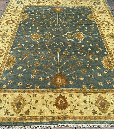 Handmade Blue Oushak Rug featuring traditional floral motifs, ivory border, and premium wool craftsmanship