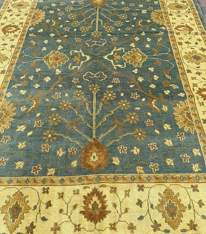 Handmade Blue Oushak Rug featuring traditional floral motifs, ivory border, and premium wool craftsmanship