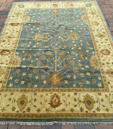 Handmade Blue Oushak Rug featuring traditional floral motifs, ivory border, and premium wool craftsmanship