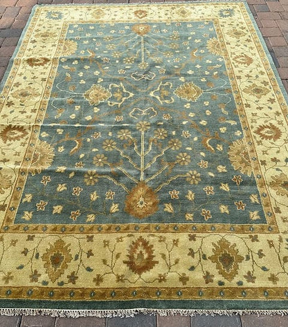Handmade Blue Oushak Rug featuring traditional floral motifs, ivory border, and premium wool craftsmanship