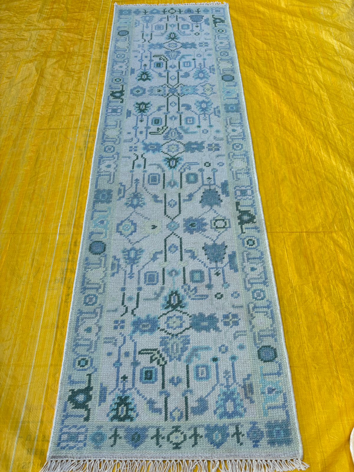 Handmade blue Oushak runner rug showcasing full length and detailed design