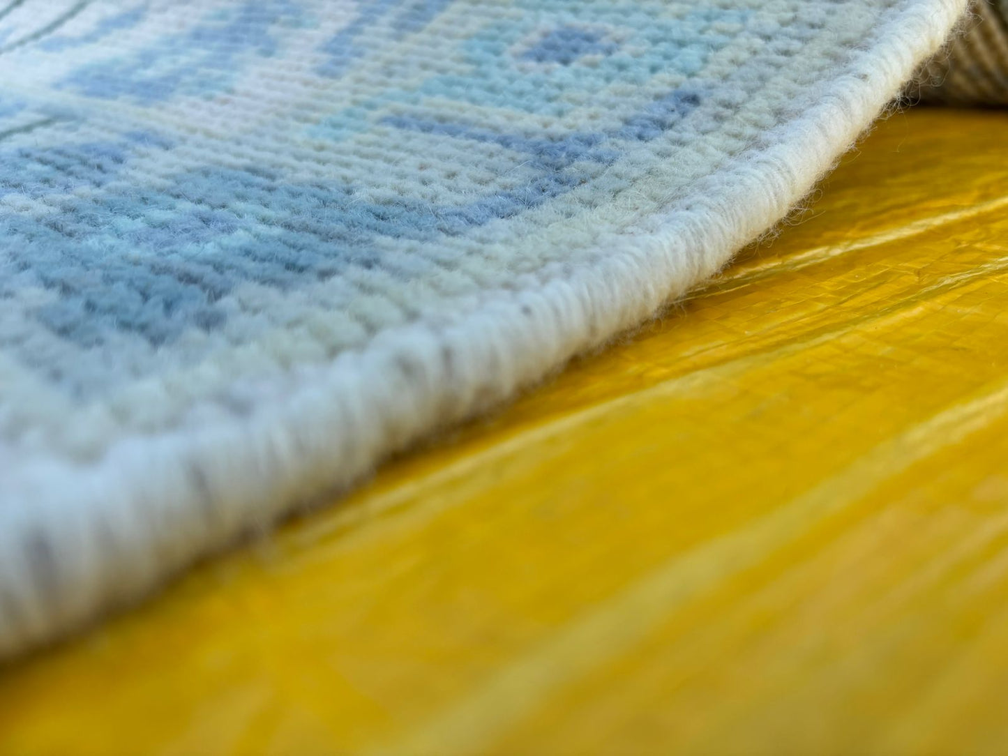 Perspective view of hand-knotted blue Oushak runner rug highlighting depth and weave