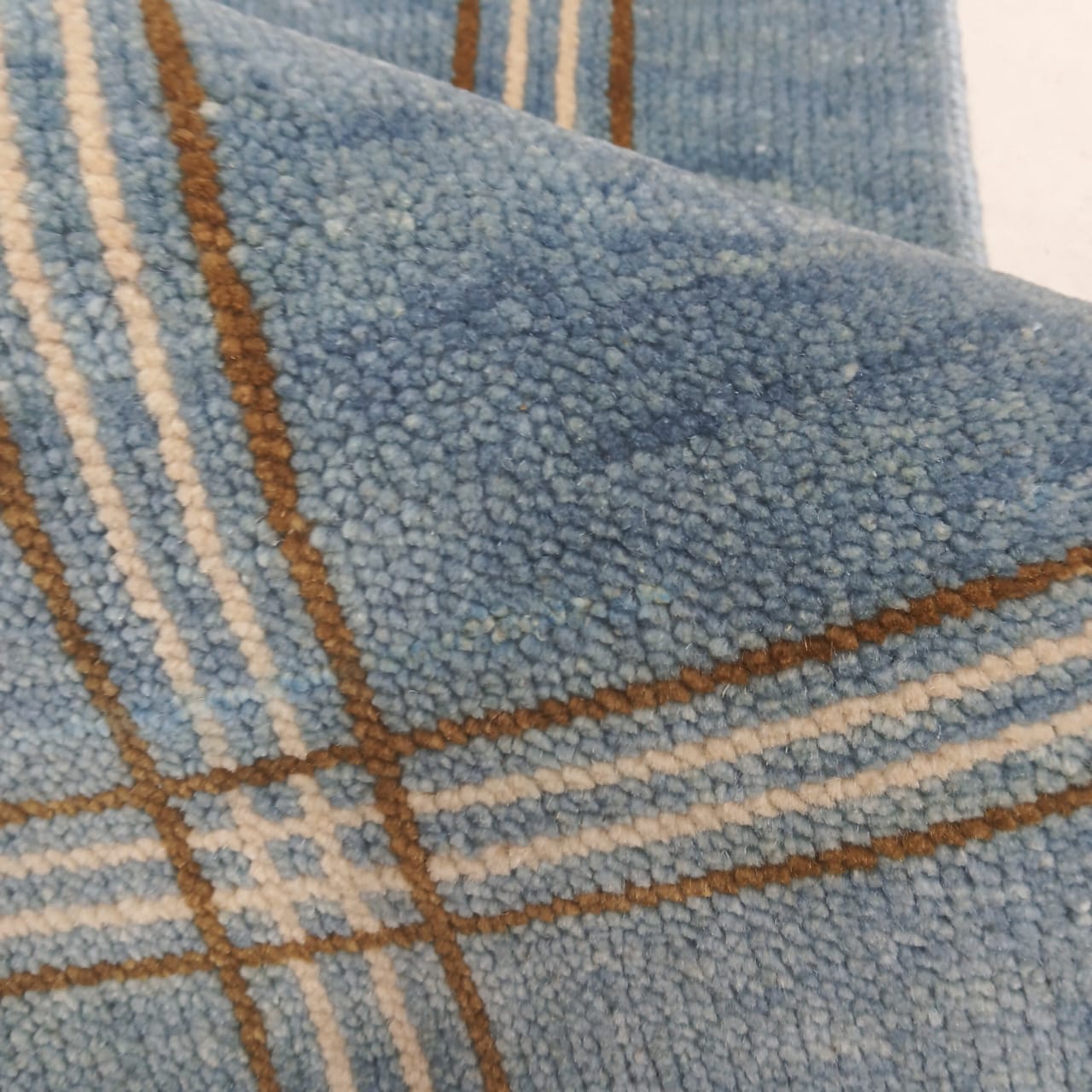 Close up of handwoven blue wool rug showing soft natural wool texture