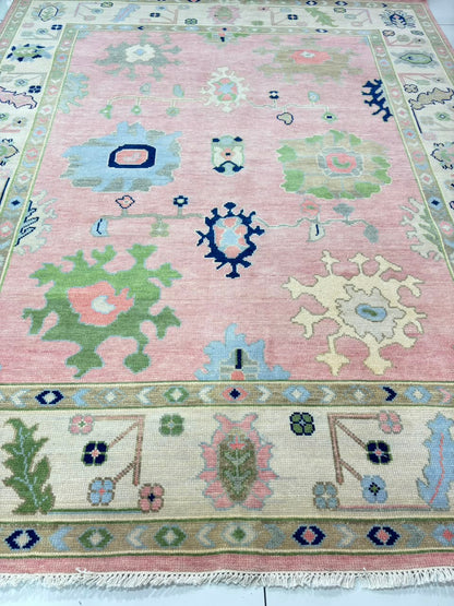 Close-up of handmade blush pink Oushak rug showing premium wool texture and artisan craftsmanship