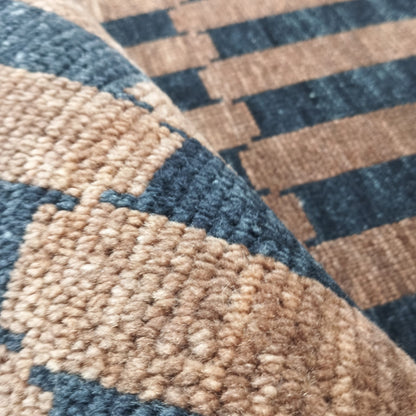 Angled view of brown and black striped handwoven wool rug
