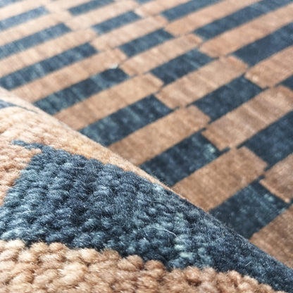 Folded edge detail of brown and black handwoven wool rug
