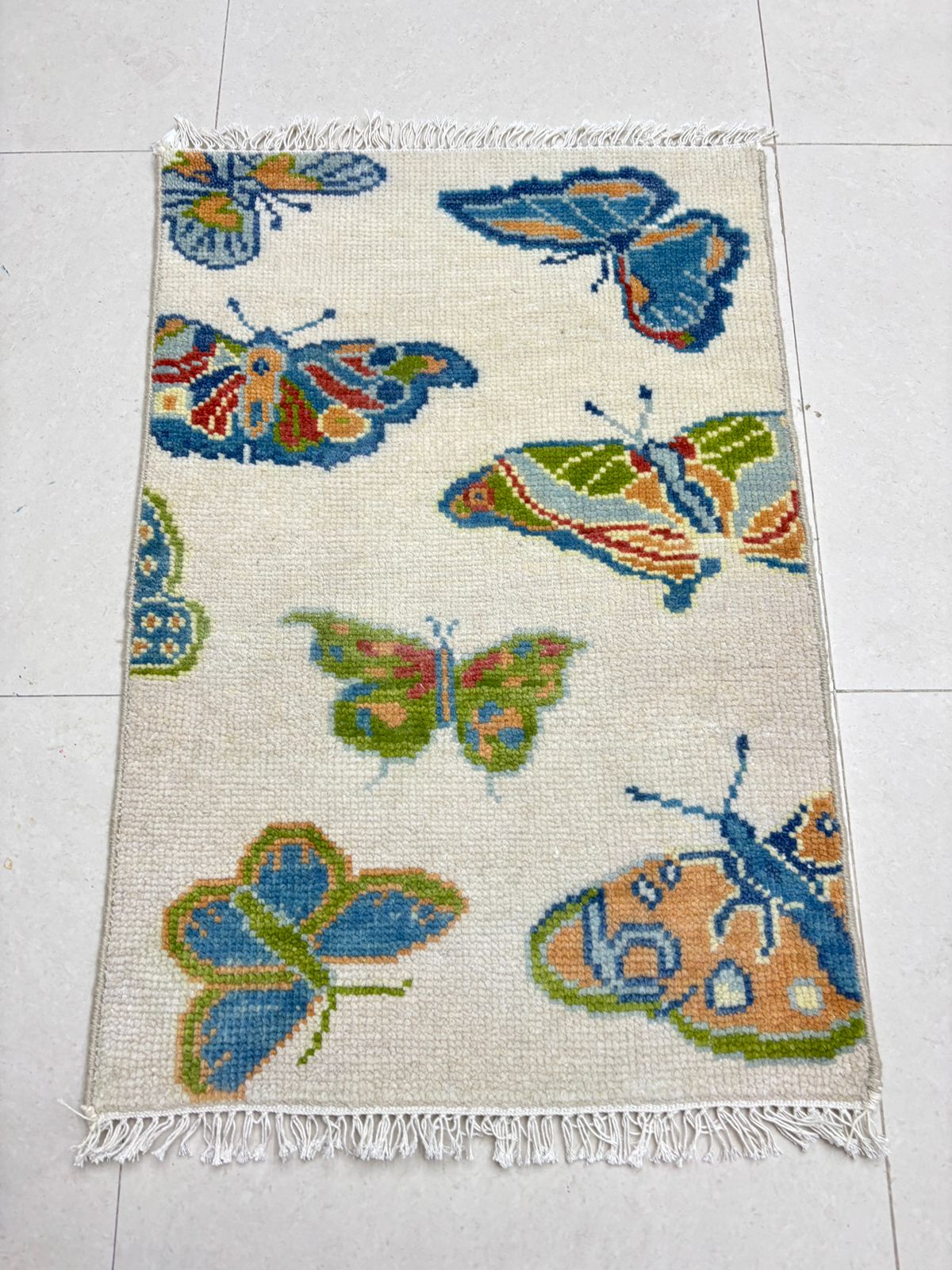 Handmade butterfly area rug with colorful butterfly pattern for nursery and kids room