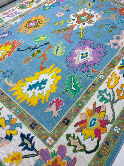 Angled view of handmade contemporary Oushak rug featuring vibrant botanical artwork