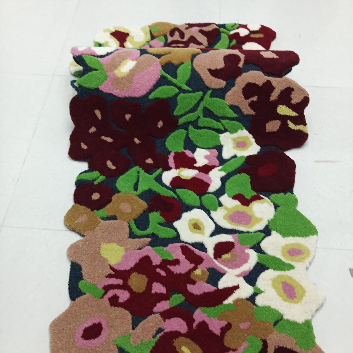 Detailed raised floral texture on a colorful botanical area rug