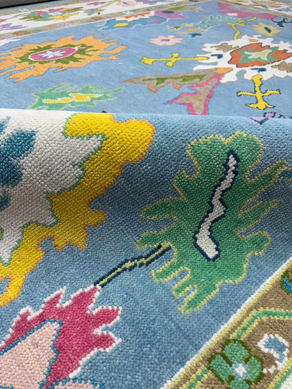 Close-up of artistic botanical motifs on handmade contemporary rug