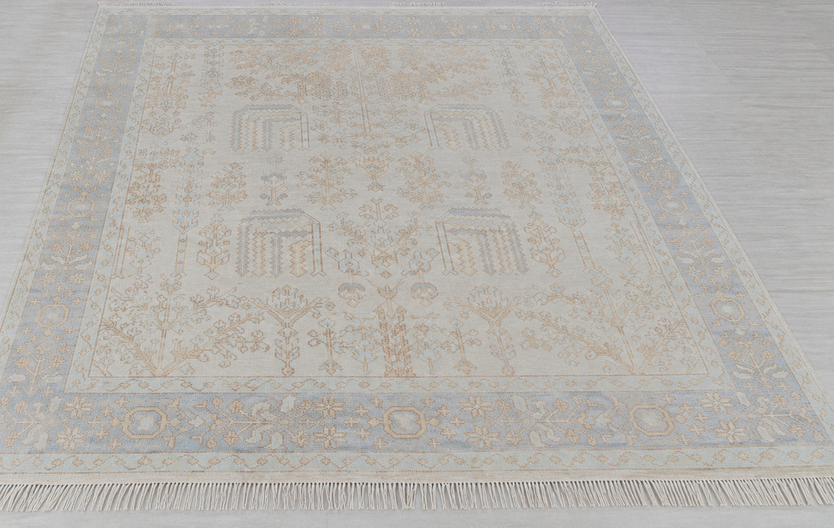 Cream and soft blue traditional floral area rug with ornate border and vintage-inspired pattern