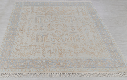 Cream and soft blue traditional floral area rug with ornate border and vintage-inspired pattern
