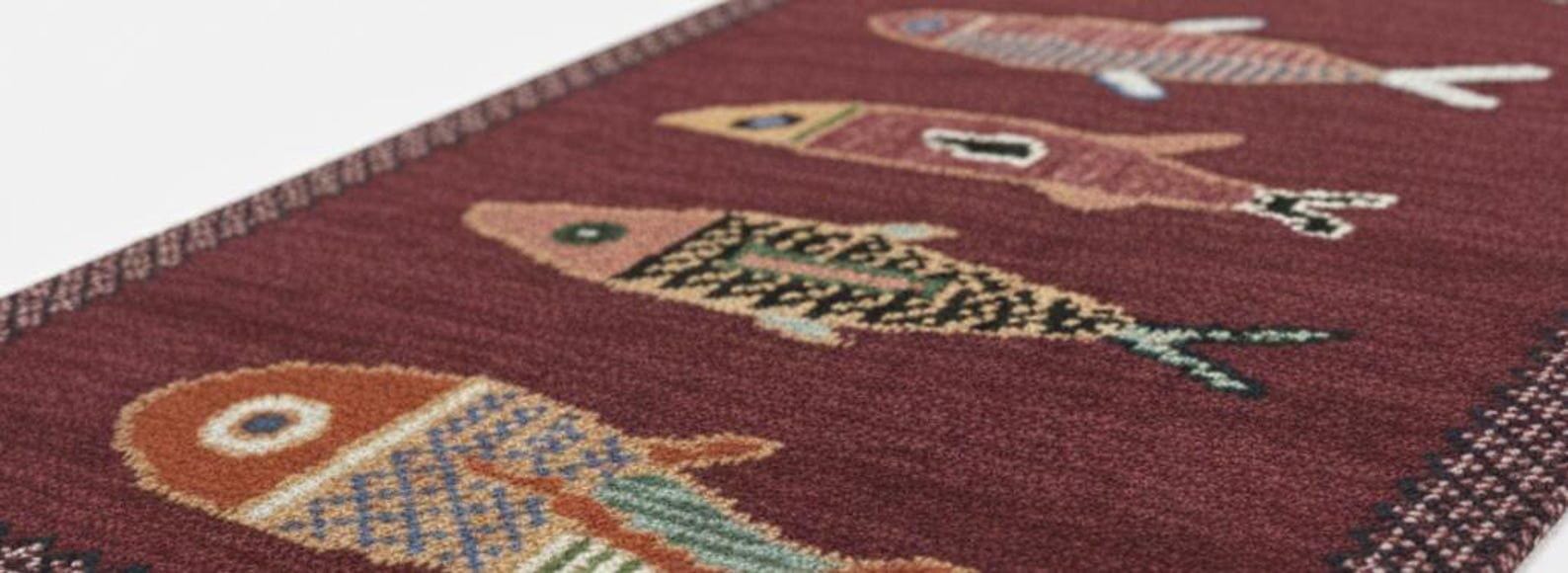 Close-up view of handmade fish runner rug showing detailed fish motifs, rich colors, and artisan weaving texture.