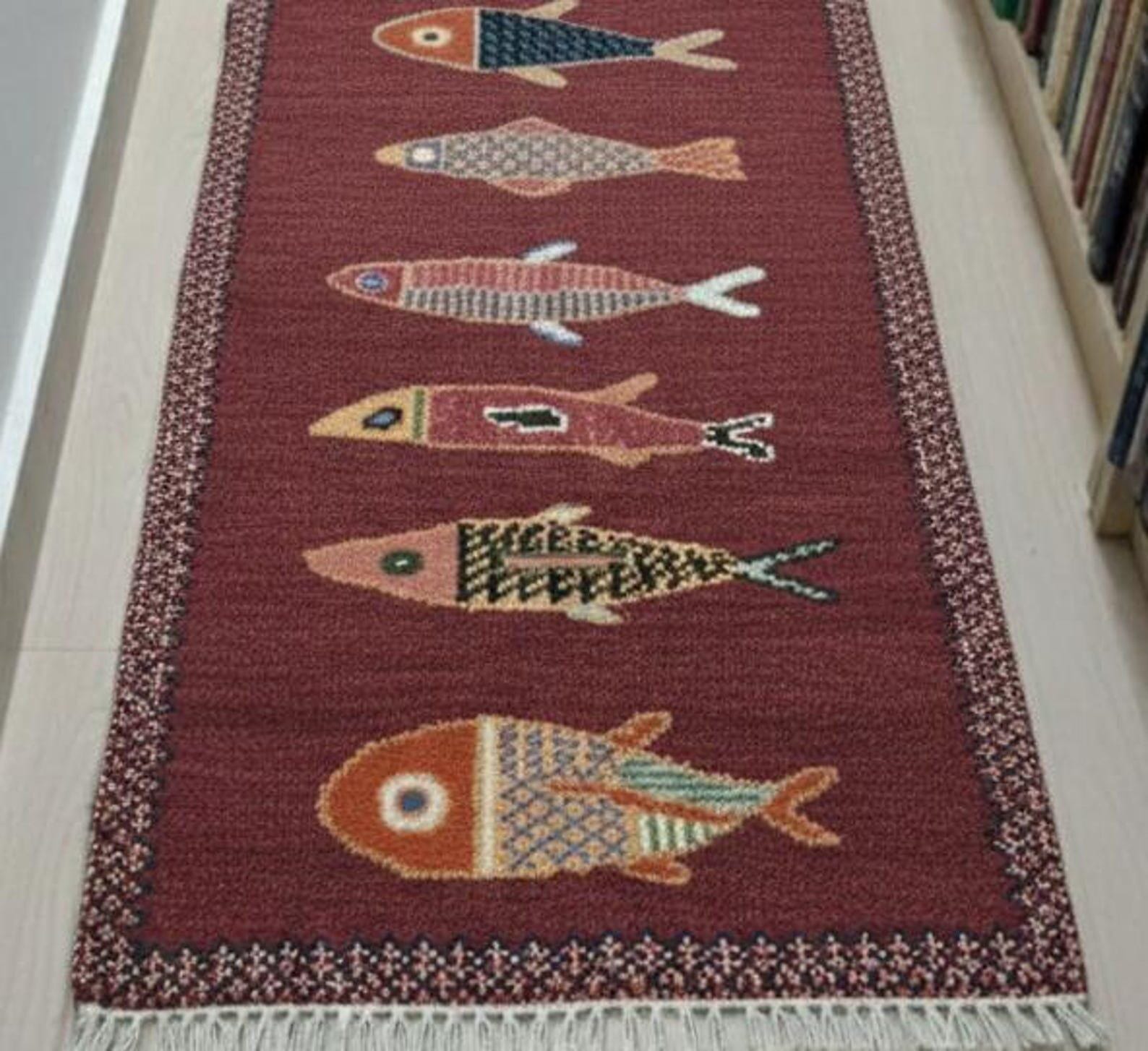 Detailed texture of handmade fish runner rug showing artisan craftsmanship, handwoven structure, and decorative fish pattern.