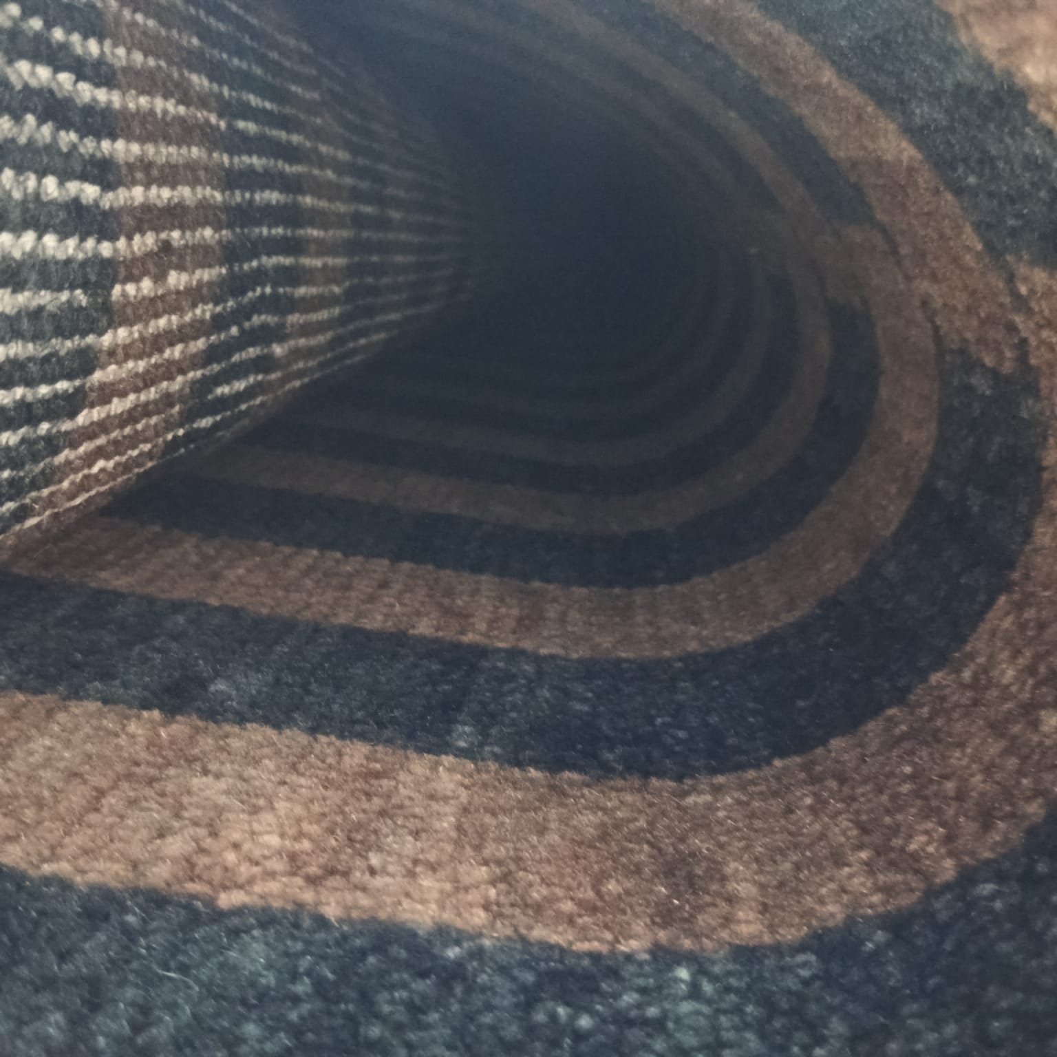 Flatwoven back detail of brown and black handwoven wool rug
