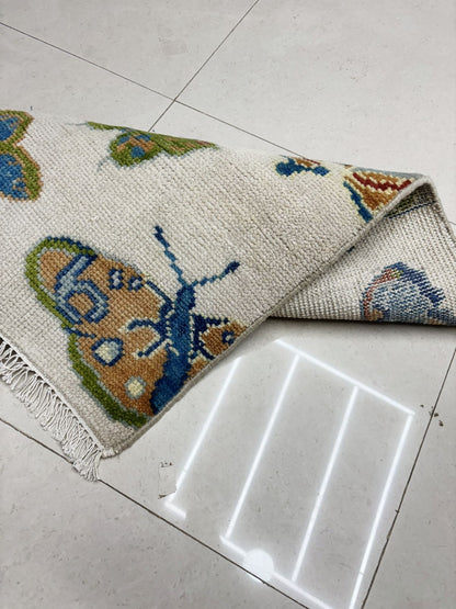 Detailed pile and texture view of handcrafted butterfly area rug